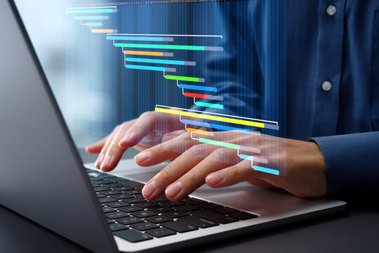Project management and task scheduling. Timeline and project tracking. Businessman using laptop computer for managing projects and tasks.