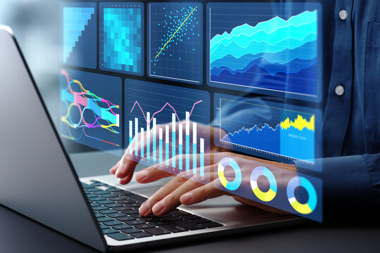 Marketing analysis of customer behavior data. Graphs of statistical web analytics and predictive financial analytics on dashboard. Analyst using laptop computer to analyze data.