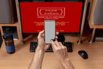 Man having operating system error calling to tech support. Man's rear view, monitor displaying...