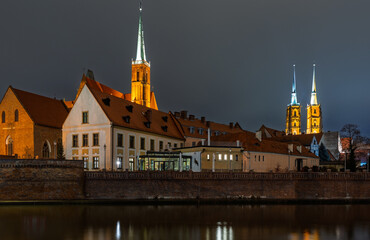 Illuminated Cathedral Towers and Historic Buildings at Night in Wroclaw, Poland..