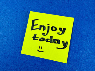 Sticker with text “Enjoy today” on blue background