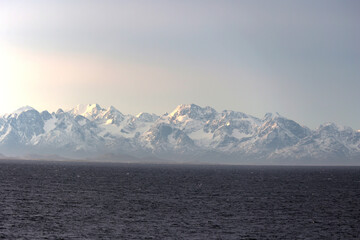 Snow-capped mountain range on the Greenland coast, Greenland