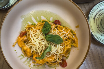 Spaghetti with shrimps on a plate in a cafe. Selective focus.