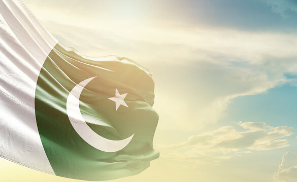 Pakistan flag wave in soft clouds National flag beautifully waving in the sky. Pakistan national flag for independence day.