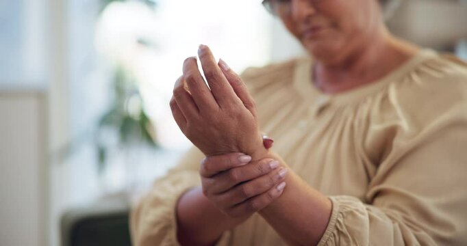 Wrist pain, home and senior woman with injury, strain and inflammation for arthritis symptoms. Retirement, health and hands of mature person with ache, spasm and medical crisis for osteoporosis