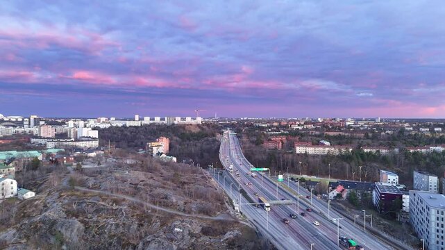 Cars on a motorway, near Stockholm, Sweden, spectacular colors in the sky, aerial view. Essingeleden E4 road.