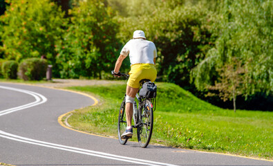 Cyclist ride on the bike path in the city Park
