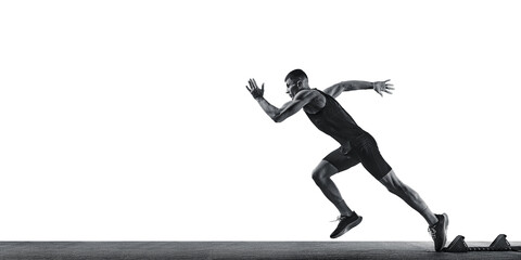 Dynamic photo of young athletic man, professional runner runs up quickly in action against white studio background. Monochrome filter. Concept of sport, healthy lifestyle, championship, action. Ad