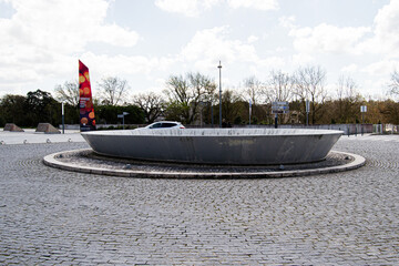 Modern roundabout sculpture in Fatima, Portugal surrounded by cobblestones and nature