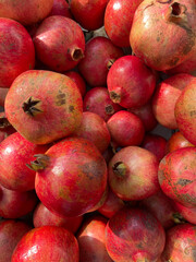 lots of ripe red pomegranate fruits for cooking as background