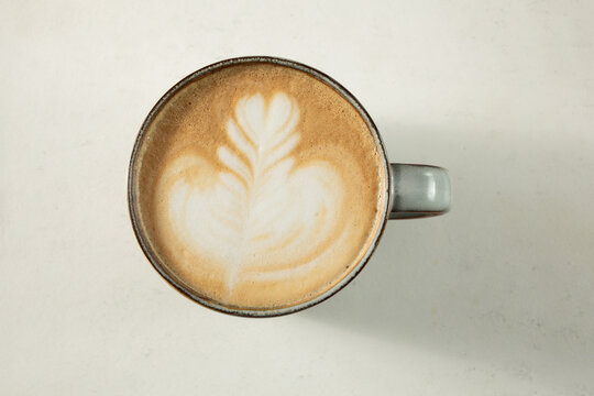 A top down view of a coffee drink with latte art.