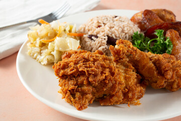 A closeup view of a Jamaican 2-piece fried chicken entree.