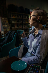 Woman in suit with books reading in restaurant