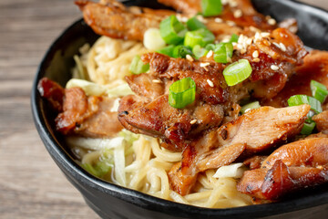 A closeup view of a bowl of Saimin teriyaki chicken.