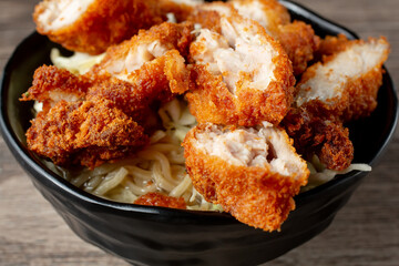 A closeup view of a bowl of Saimin chicken katsu.