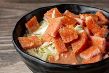 A closeup view of a bowl of saimin Spam.