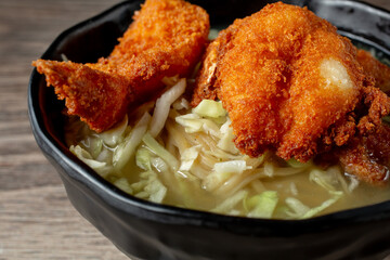 A view of a bowl of Saimin chicken katsu.