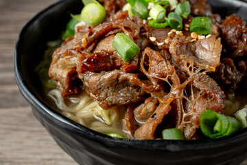 A closeup view of a bowl of saimin beef teriyaki.