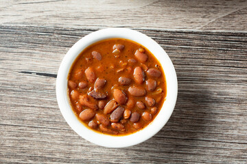 A top down view of a bowl of bbq baked beans.