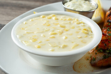 A closeup view of a bowl of creamed corn.