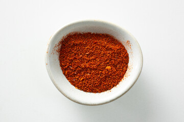 A top down view of a condiment cup of Harissa powder.