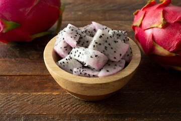 A view of a bowl of chopped red dragon fruit.