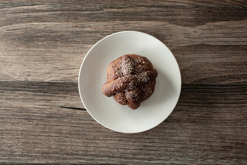 A top down view of pan de muerto on a plate.