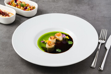 Scallops with two types of sauces and caviar on top