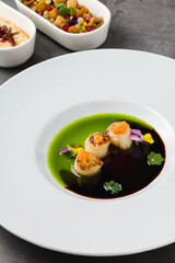 Scallops with two types of sauces and caviar on top