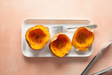 A top down view of a tray of roasted honeynut squash.