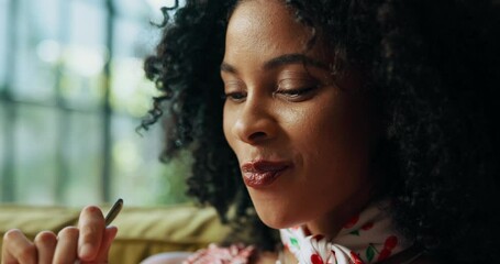 Black woman, ice cream and happy on sofa with smile for satisfaction, eating and craving in house. African girl, gelato and snack in home living room on couch for frozen dessert or yogurt and sweets