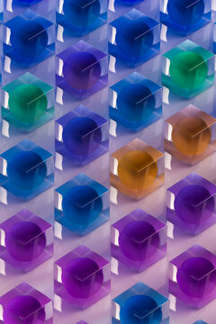 Colorful balls inside glass cubes arranged in a geometric pattern