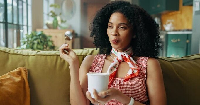 Woman, ice cream and snack on sofa with smile for satisfaction, eating and craving in house. African girl, gelato and happy in home living room on couch for frozen dessert or yogurt and sweets