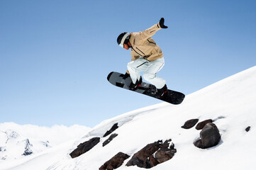 athlete man performing tricks on snowboard, exuding confidence and control in vibrant winter gear...