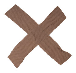 Isolated cross made from brown bactericidal plaster on white background, copy space