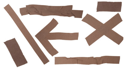 Isolated collection of torn brown bactericidal plaster figures: stripes, crosses, arrows on white background, copy space