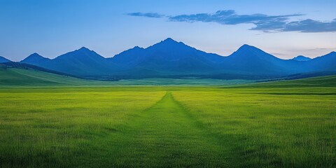 Panoramic View of Lush Green Meadow with Majestic Mountains Under a Clear Blue Sky at Dusk in the Western Region