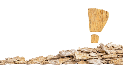 Creative composition featuring wooden exclamation mark above a pile of textured stones representing surprise, curiosity, and natural elements in design concepts.