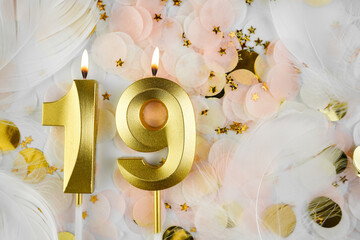 Nineteenth Birthday Celebration with Gold Candle and Confetti. Golden numeral nineteen birthday...