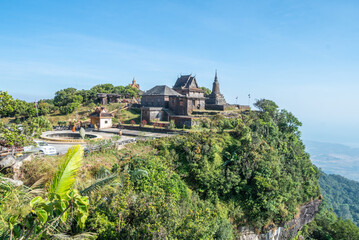 Naklejka premium An impressive building atop a lovely hill, surrounded by trees, Bokor National Park
