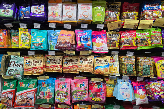 Bangsar, Malaysia &ndash; Mar 29, 2025: Various packaged candies including gummies, toffees, and sugar-free treats displayed on a supermarket shelf in the confectionery section.