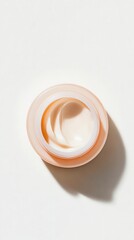 top shot of skincare shows cream delicate swirls, evoking feeling of luxury and self care. It is smooth, and pleasing treatment