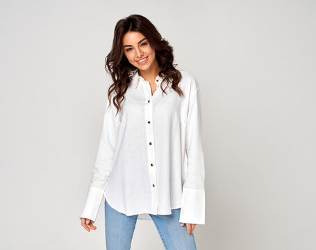 Smiling european woman looking at camera on gray background, copy space. Advertisement concept