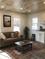 Fototapeta premium Warm, inviting living room with wood accents and a cozy brown couch. Natural light streams through windows overlooking trees. A peaceful retreat
