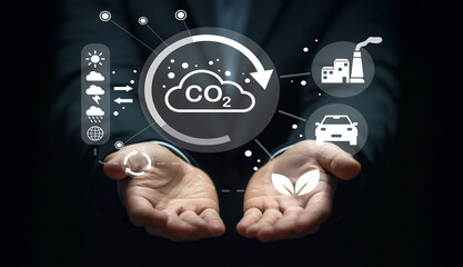 Conceptual Image of Hands Holding CO2 Reduction Symbols and Icons Representing Climate Change Solutions and Sustainable Development in Business Context