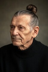 Obraz premium Portrait of a Thoughtful Senior Man with Hair in a Top Knot