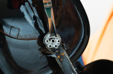 Close-up of a rusty, aged coffee grinder's internal mechanism, showcasing its worn metal components...
