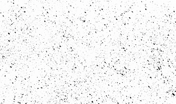 This image features a scattered pattern of black specks over a stark white background, creating visual texture.
