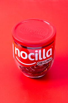 Nocilla brand cocoa cream jar isolated on red background