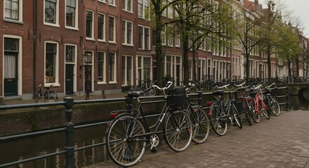 Fototapeta premium Amsterdam canal with bikes parked.
